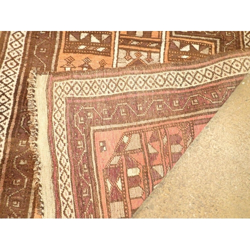 1374 - A Turkoman style rug with geometric design on a coral ground 131 x 95cm