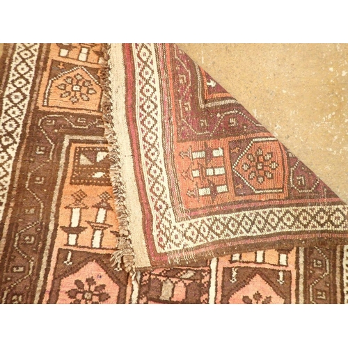 1374 - A Turkoman style rug with geometric design on a coral ground 131 x 95cm