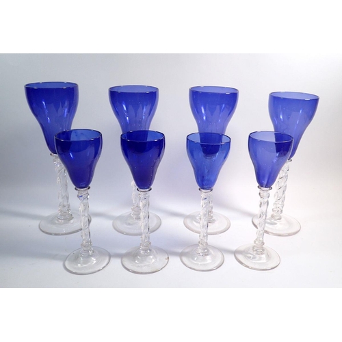 143 - A set of four large blue bowl glass wine goblets on spiral stems, 30cm tall and four smaller ones