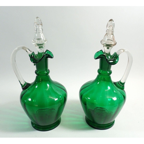 171 - A pair of green glass claret decanters, 29cm