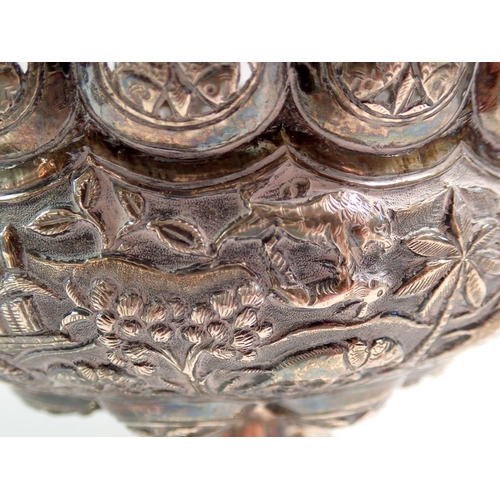 196 - An Indian silver fruit bowl with pierced rim and embossed decoration of elephants and other animals,... 