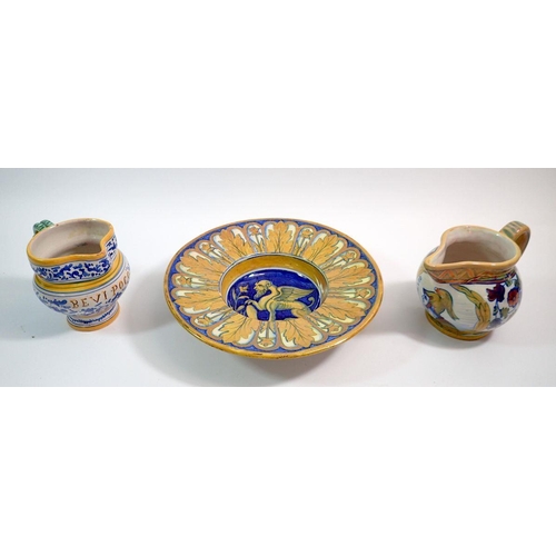 21 - An Italian Maiolica dish painted griffin, 24cm diameter and two Maiolica jugs