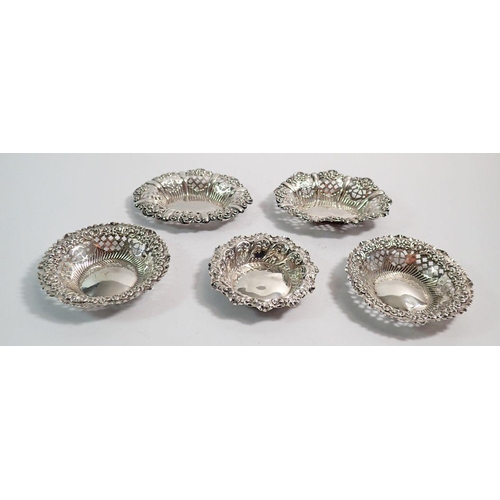 213 - Two pairs of Indian white metal pierced and embossed bon bon dishes, 96g plus a English silver one, ... 