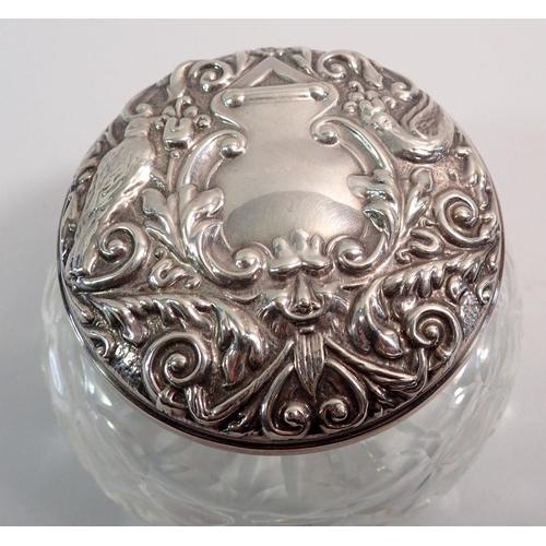 223 - A silver and cut glass powder bowl with mirror to inner lid, embossed bird decoration, Birmingham 19... 