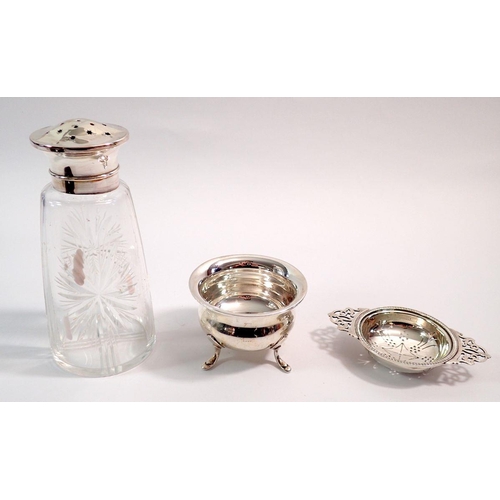 223A - A silver circular bowl on hoof feet, Sheffield 1931, 79g and a silver tea strainer, Sheffield 1961, ... 