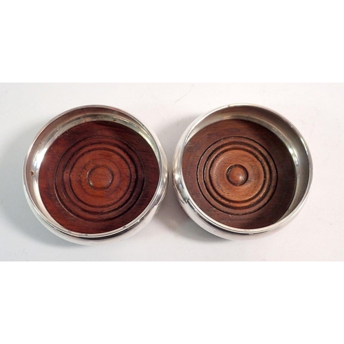 224 - A pair of silver and turned wood bottle coasters, London 1989 by John Bull