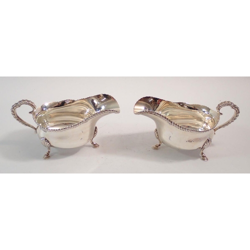 250 - A pair of silver sauce boats on shell and hoof feet, Sheffield 1948 by Goldsmiths & Silversmiths Co.... 