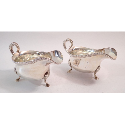 250 - A pair of silver sauce boats on shell and hoof feet, Sheffield 1948 by Goldsmiths & Silversmiths Co.... 