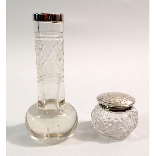 255 - A cut glass small bud vase with silver rim, Chester 1897, 10cm tall and a silver topped small toilet... 