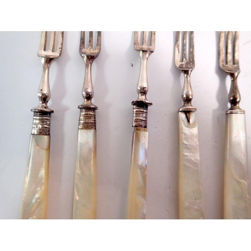 262 - A mother of pearl and silver set of dessert cutlery comprising eight knives and six forks plus three... 