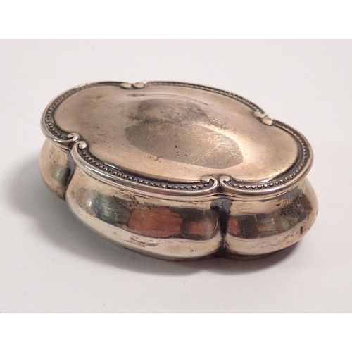 287 - A Victorian oval lobed silver snuff box with beaded and scroll border, 6cm wide, Birmingham 1899