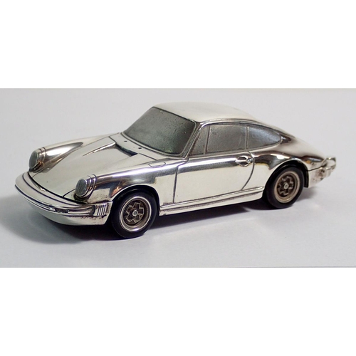 294 - A silver model Porsche 911 marked Baujhar 1977 etc to base, with Porsche design titanium lighter in ... 