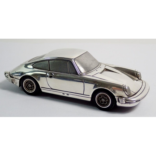 294 - A silver model Porsche 911 marked Baujhar 1977 etc to base, with Porsche design titanium lighter in ... 