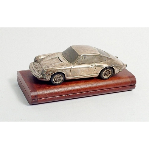 294 - A silver model Porsche 911 marked Baujhar 1977 etc to base, with Porsche design titanium lighter in ... 