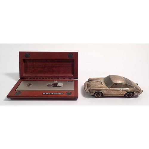 294 - A silver model Porsche 911 marked Baujhar 1977 etc to base, with Porsche design titanium lighter in ... 