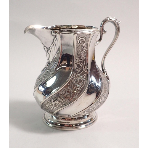 310 - A Victorian silver cream jug with engraved decoration to swirled panel body, Sheffield 1896, by John... 