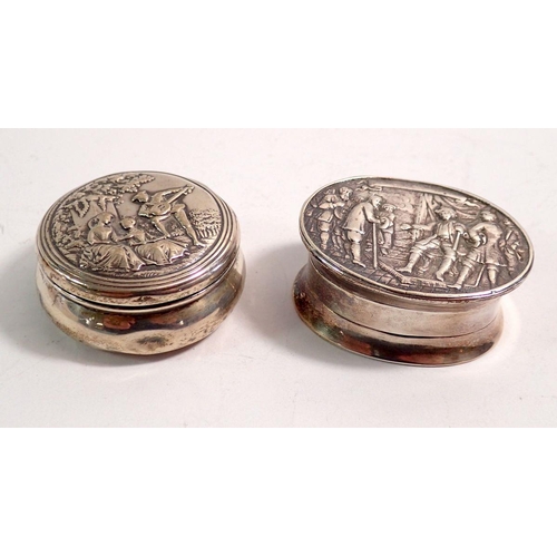 316 - A Dutch oval 925 silver pill box embossed figurative scene 43g 4.9 x 4cm and a circular silver box e... 