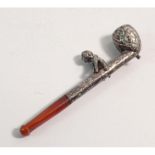 325 - An unusual 19th century miniature white metal pipe with monkey to stem and amber mouthpiece, 7cm