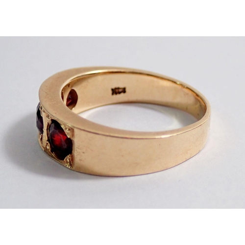 349 - A 14kt gold ring inset three garnets, size N to O, 6.3g