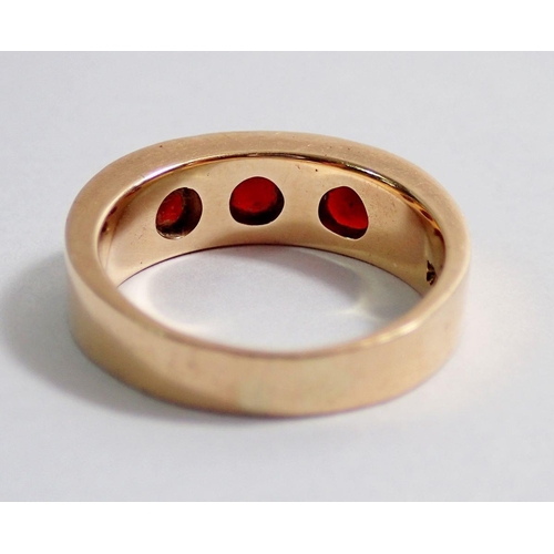 349 - A 14kt gold ring inset three garnets, size N to O, 6.3g