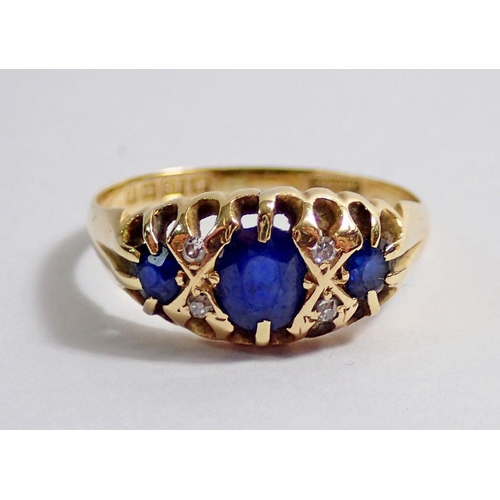 350 - An 18 carat gold ring set three sapphires and four chip diamonds, size Q, 3g