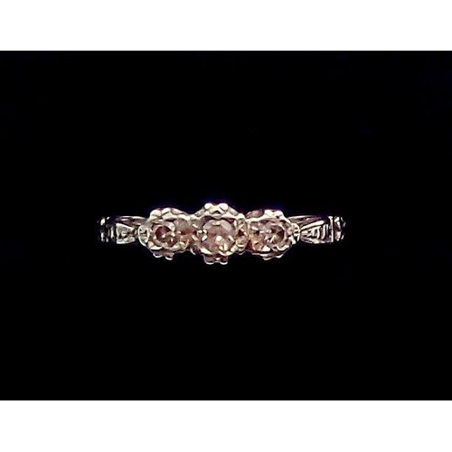 352 - An Edwardian gold ring illusion set three diamonds, size G, 2.5g