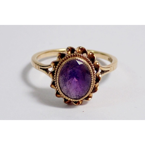 353 - A 9 carat gold oval cut amethyst cluster ring, 1.2 x 1.1cm, size O, 2.6g