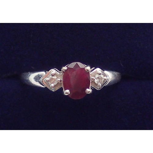 360 - A 9 carat white gold ring set ruby flanked by two diamonds, size O to P, 2.1g