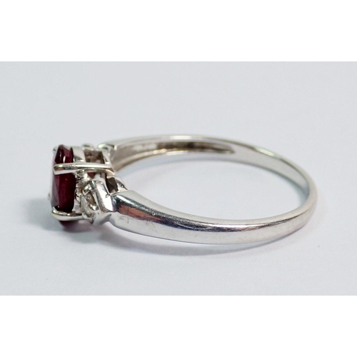 360 - A 9 carat white gold ring set ruby flanked by two diamonds, size O to P, 2.1g