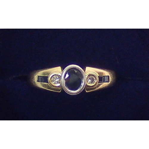 364 - An 18 carat gold modern ring set sapphire flanked  by two diamonds on baguette cut sapphire shoulder... 