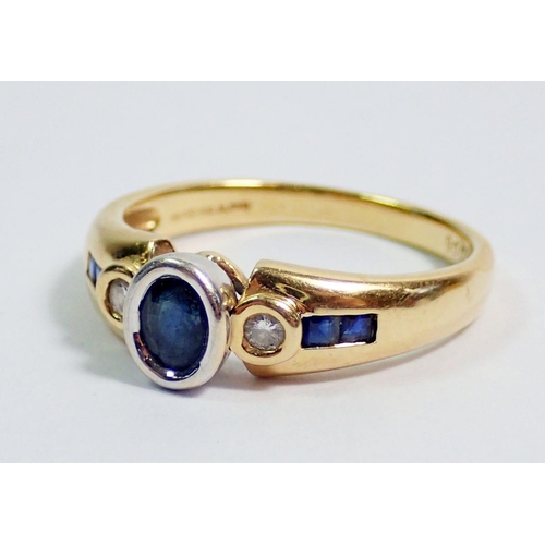 364 - An 18 carat gold modern ring set sapphire flanked  by two diamonds on baguette cut sapphire shoulder... 