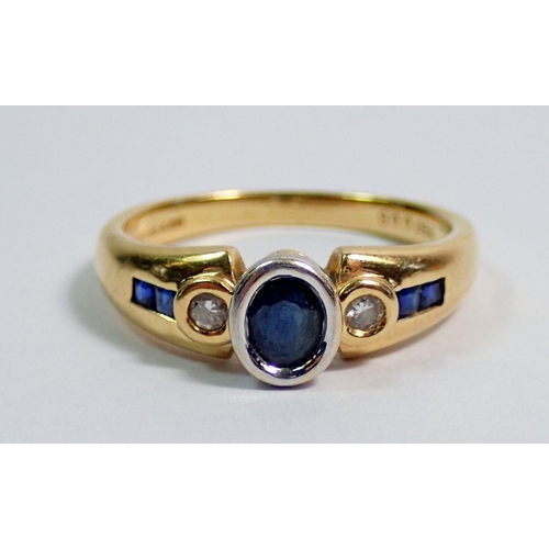 364 - An 18 carat gold modern ring set sapphire flanked  by two diamonds on baguette cut sapphire shoulder... 