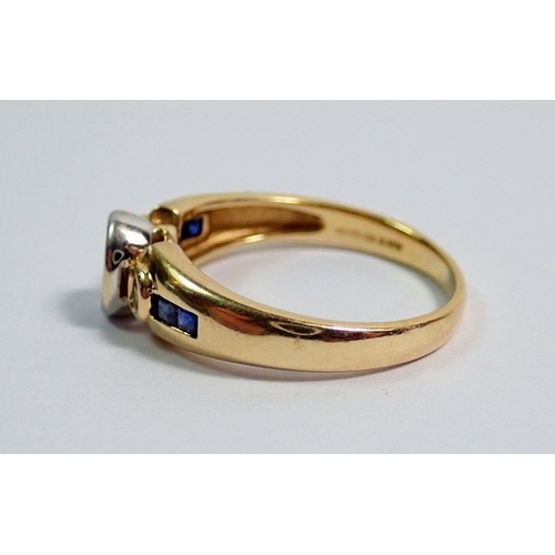 364 - An 18 carat gold modern ring set sapphire flanked  by two diamonds on baguette cut sapphire shoulder... 