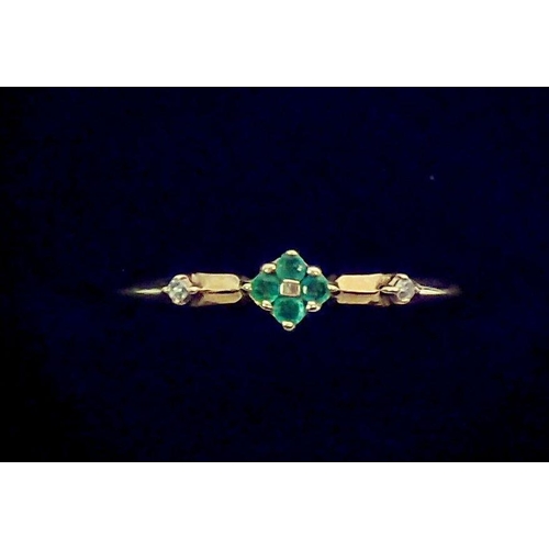 367 - A 9 carat gold ring set two chip diamonds flanking small emerald cluster, size Q to R