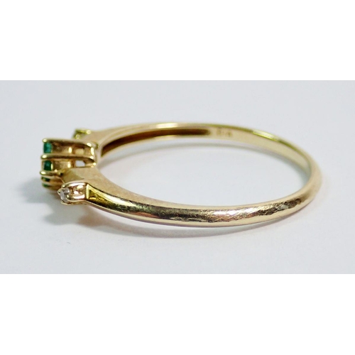 367 - A 9 carat gold ring set two chip diamonds flanking small emerald cluster, size Q to R