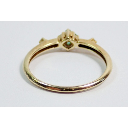 367 - A 9 carat gold ring set two chip diamonds flanking small emerald cluster, size Q to R