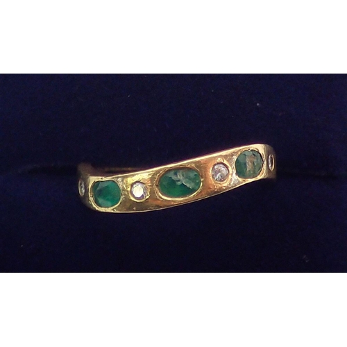 373 - A Portuguese gold ring set three emeralds and four small diamonds on serpentine band, size L (two em... 