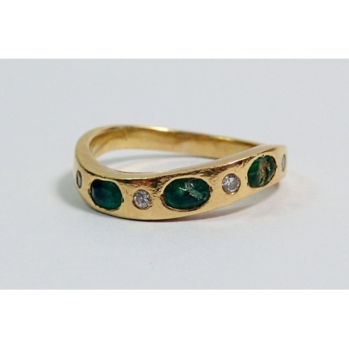 373 - A Portuguese gold ring set three emeralds and four small diamonds on serpentine band, size L (two em... 