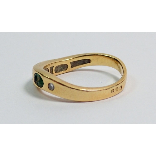 373 - A Portuguese gold ring set three emeralds and four small diamonds on serpentine band, size L (two em... 