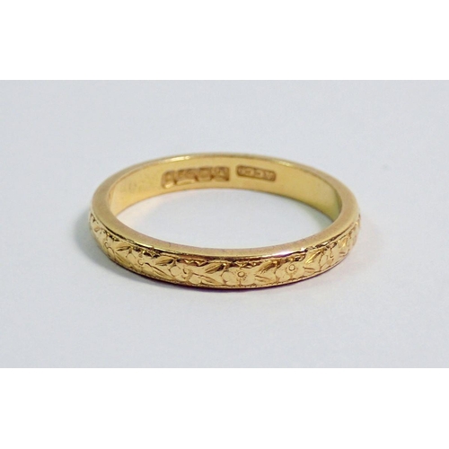 375 - A 22 carat gold wedding band with floral chased decoration, size N, 3.7g