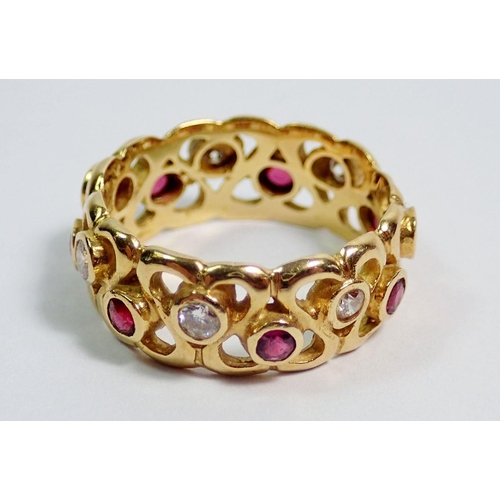 377 - An 18 carat gold ring with pierced decoration to band and set rubies and diamonds, size N, 5.8g