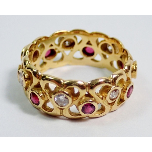 377 - An 18 carat gold ring with pierced decoration to band and set rubies and diamonds, size N, 5.8g