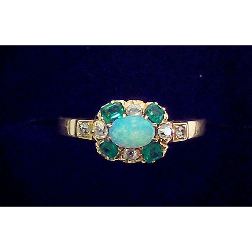 381 - A gold ring set oval opal within emerald and diamond surround, unmarked but thought to be 18 carat, ... 