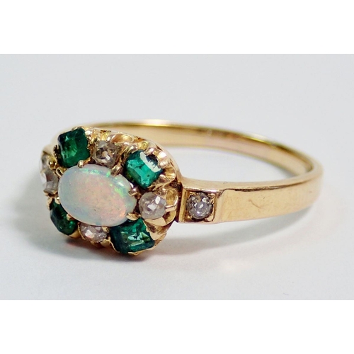 381 - A gold ring set oval opal within emerald and diamond surround, unmarked but thought to be 18 carat, ... 