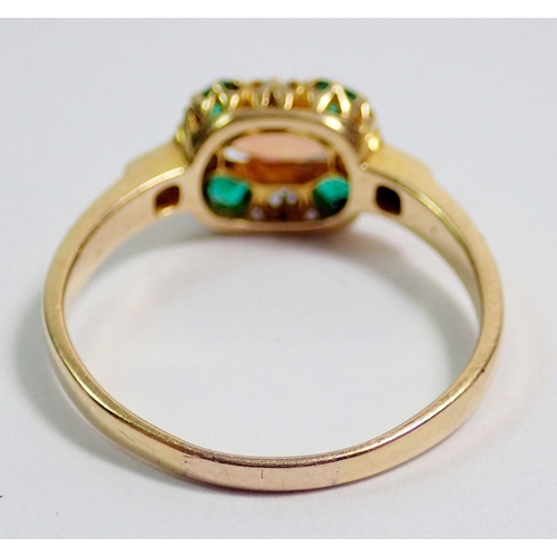 381 - A gold ring set oval opal within emerald and diamond surround, unmarked but thought to be 18 carat, ... 