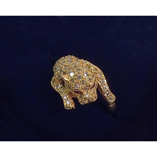 384 - An 18 carat gold diamond set ring in the form of a leopard, with ruby eyes, size K, 5.5g