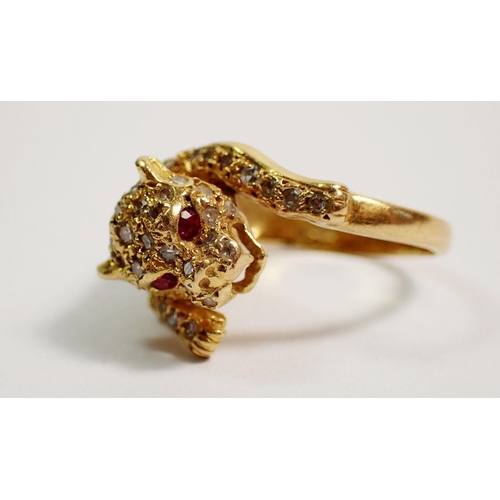 384 - An 18 carat gold diamond set ring in the form of a leopard, with ruby eyes, size K, 5.5g