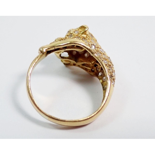 384 - An 18 carat gold diamond set ring in the form of a leopard, with ruby eyes, size K, 5.5g