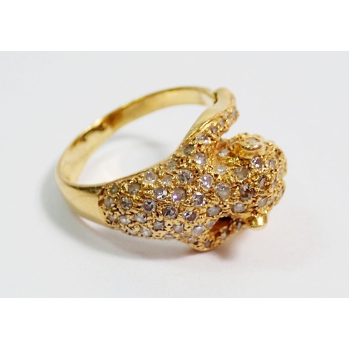 384 - An 18 carat gold diamond set ring in the form of a leopard, with ruby eyes, size K, 5.5g