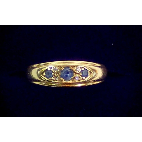 392 - An 18 carat gold ring set three sapphires and four chip diamonds, size J, 3.5g